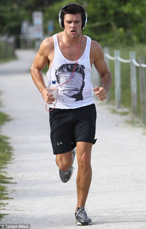 Leandro Penna passes the time without Katie Price as he hits the beach in Miami for a morning jog    1